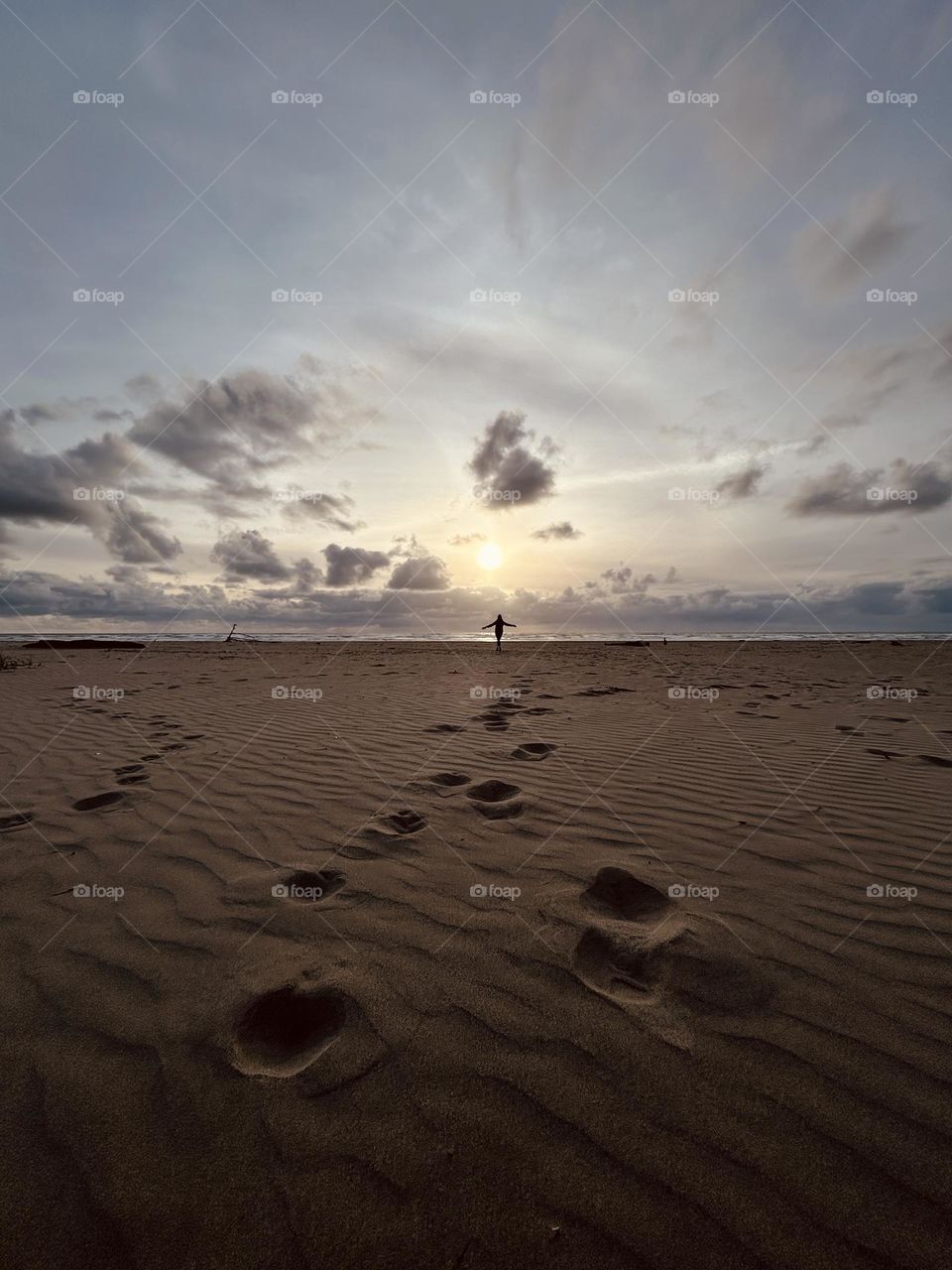 Celebrating on an Oregon beach at sunset. Picture photographed at Seaside, Oregon