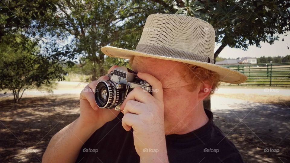 Man leaning back taking a photo