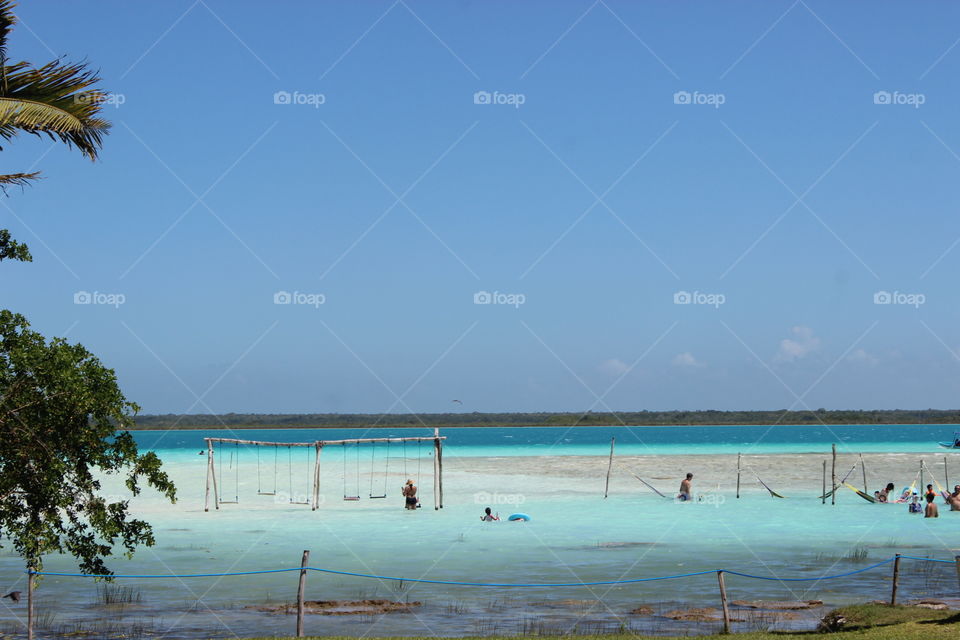 A spectacular view of The Seven Colors Lagoon in Bacalar, Quintana Roo, Mexico. The magic amenities have 50 km of 7 water colors in a calm and lovely place to experiment travel in Central America. A most of the beautiful water bodies in the world. 