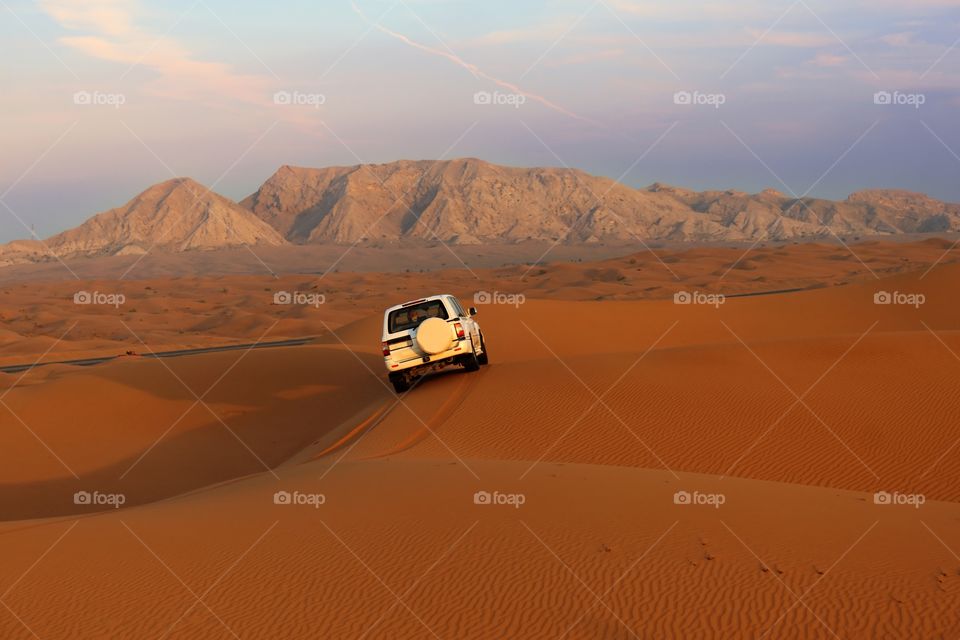 A Powerful 4x4 vehicle going through the desert, dubai, united Arab Emirates