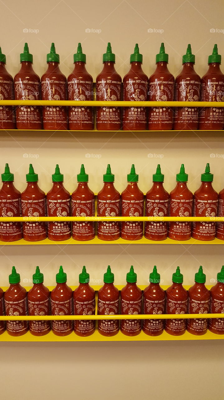 Rows n rows of hot sauce. Might set your mouth afire, but somehow soothing to the eye.