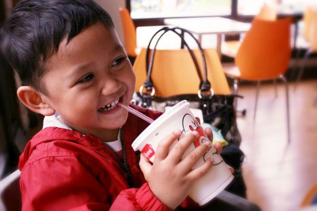 Happy boy drinking coffee