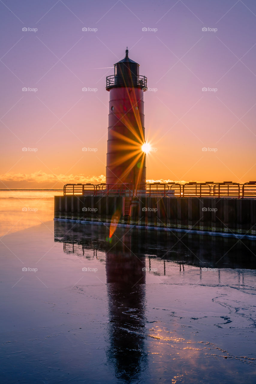 Sunrise on a cold morning in Wisconsin of the red light house on Lake Michigan