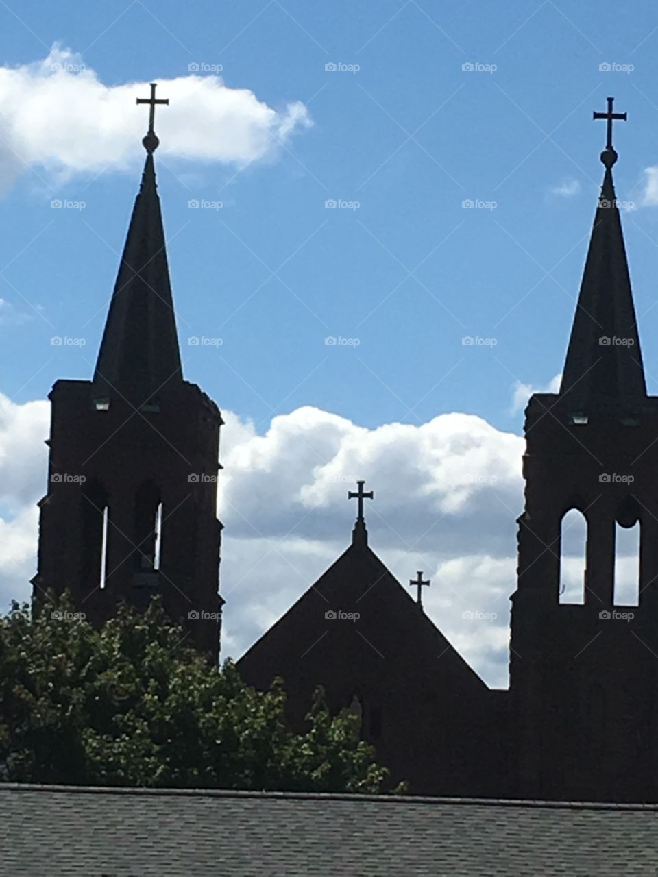 Church tower silhouettes with four crosses