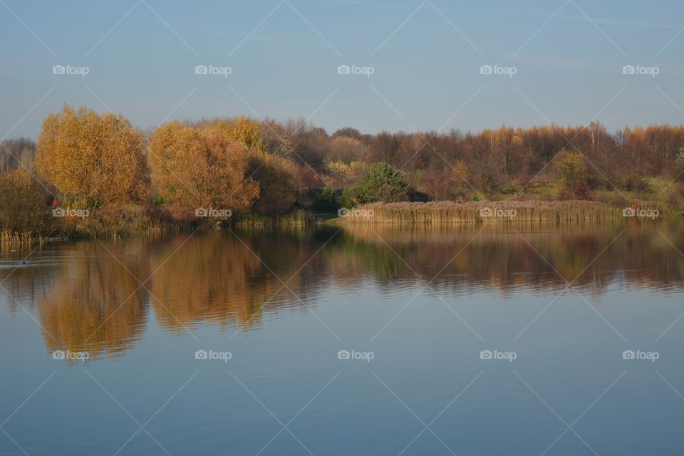 lake beautiful nature landscape and reflection autumn time blue sky background, no filters