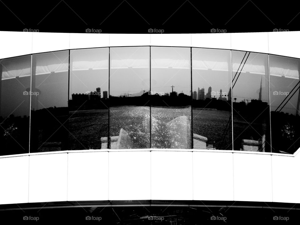 Dubai reflected. Reflection of dubai skyline on golf course window