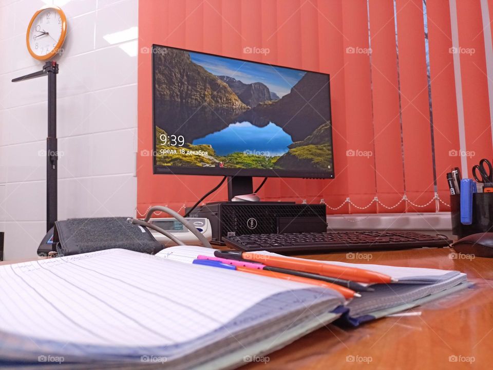 Doctor's desk, computer desk,monitor, blinds, orange,magazines,pens,phonendoscope,medical mask,doctor's office, reception room