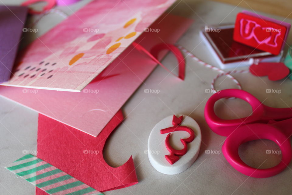Homemade Valentine's Day greeting cards with stamps and heart cutouts.
