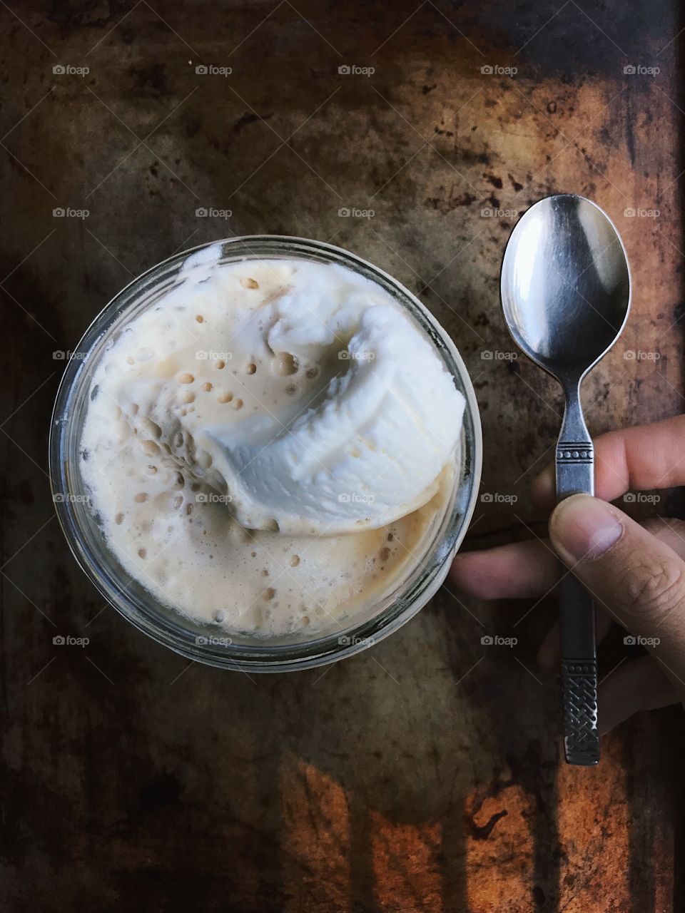 Delicious moody afternoon affogato.. This is a shot of ice cream and espresso with an old spoon. 