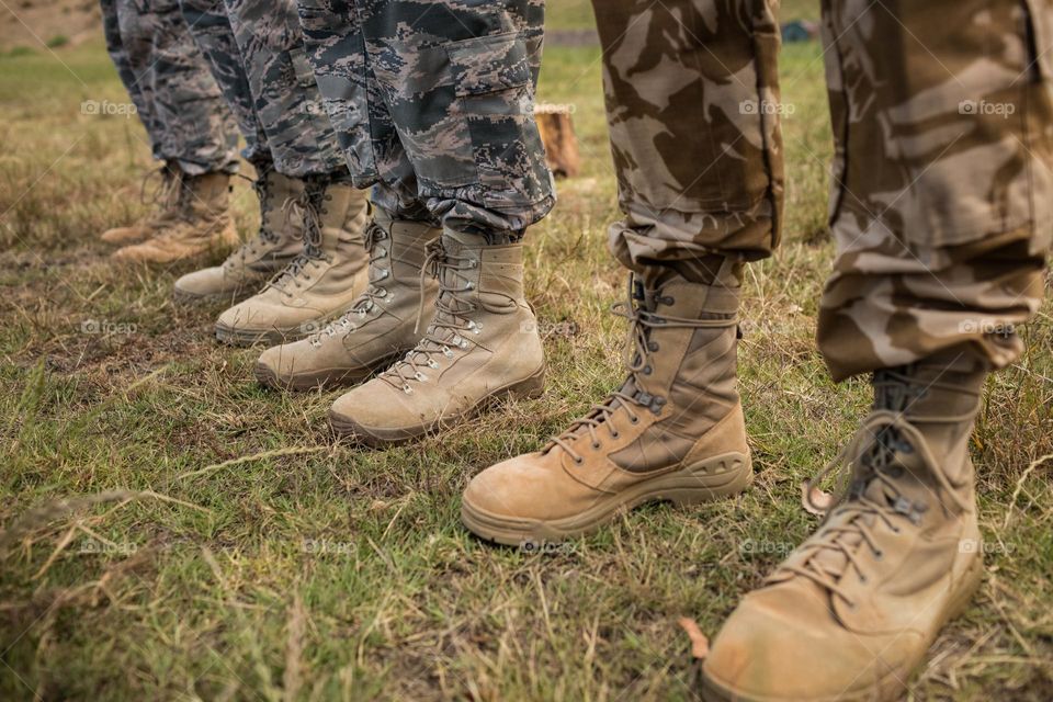 Low-section of military soldiers standing in line at boot camp