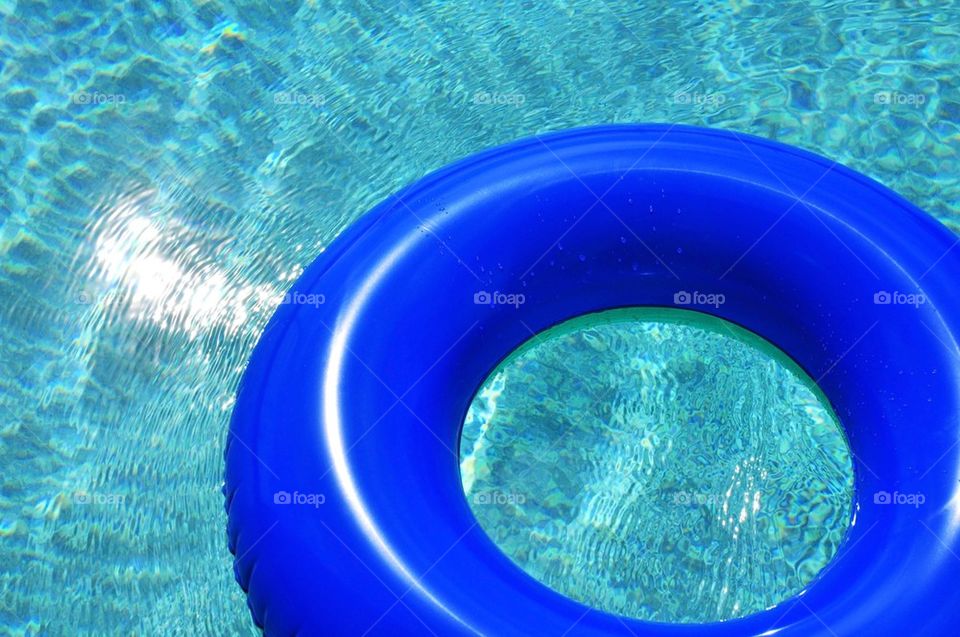 Blue pool float in swimming pool