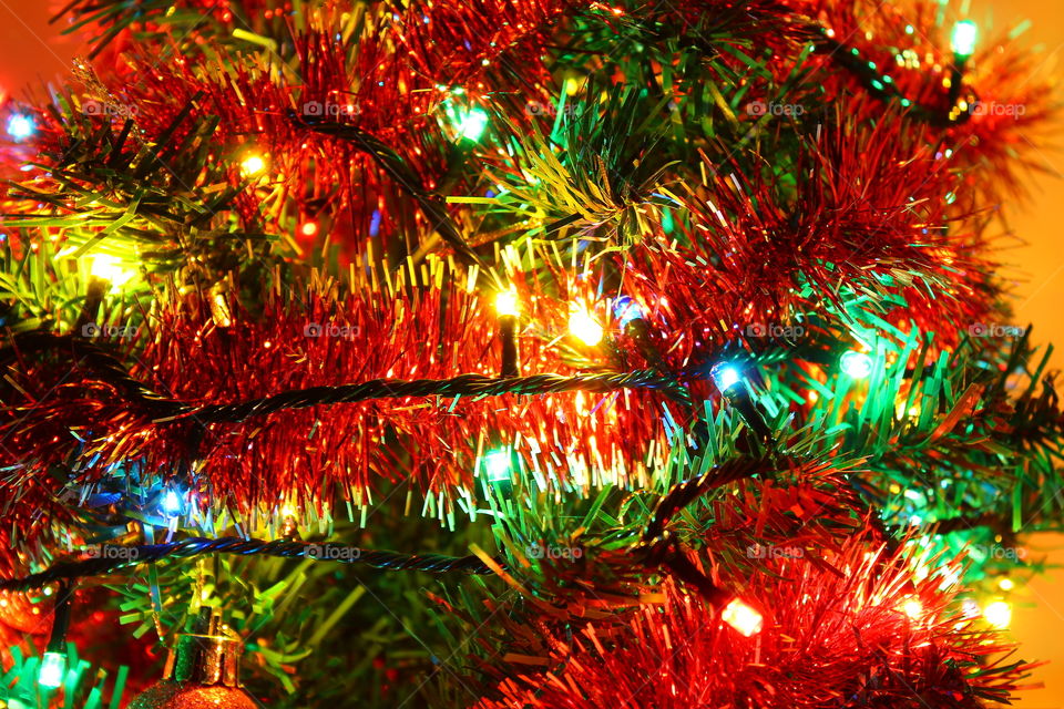 Macro shot of Christmas tree decorations and vivid lights