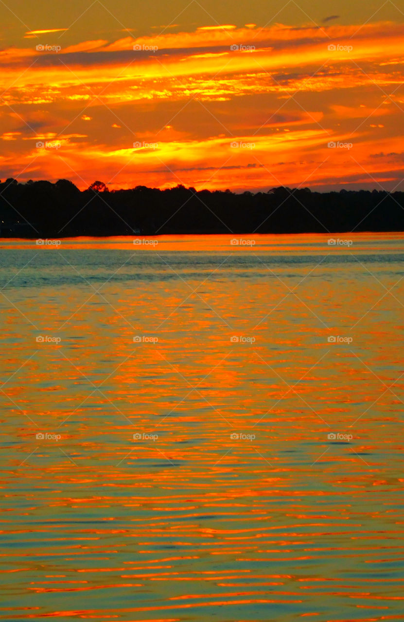 The sky was filled with the most brilliant orange complimented perfectly with hues of gold, yellow, red and crimson. An orange haze had casted over the water, reflecting off every wave.  Finally,the sun disappears along with the shine. I can only wait to see another magical moment of beauty and warmth! I can only wait for another sunset! Enjoy!