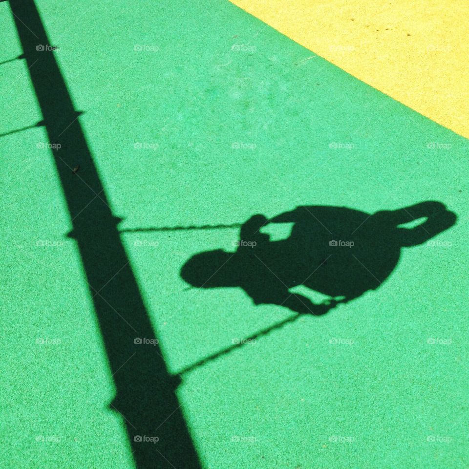 Shadow of little girl on swing