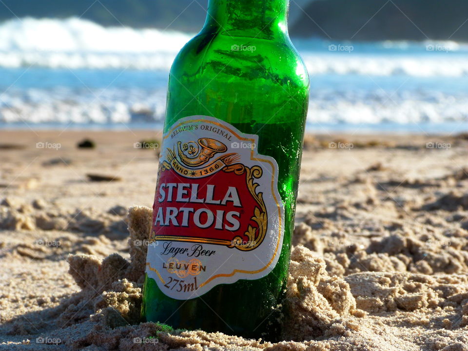 beer buried in the sand