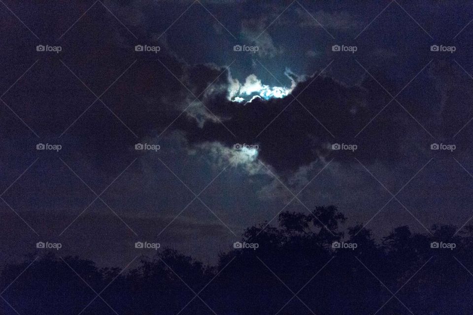 Full moon behind the clouds