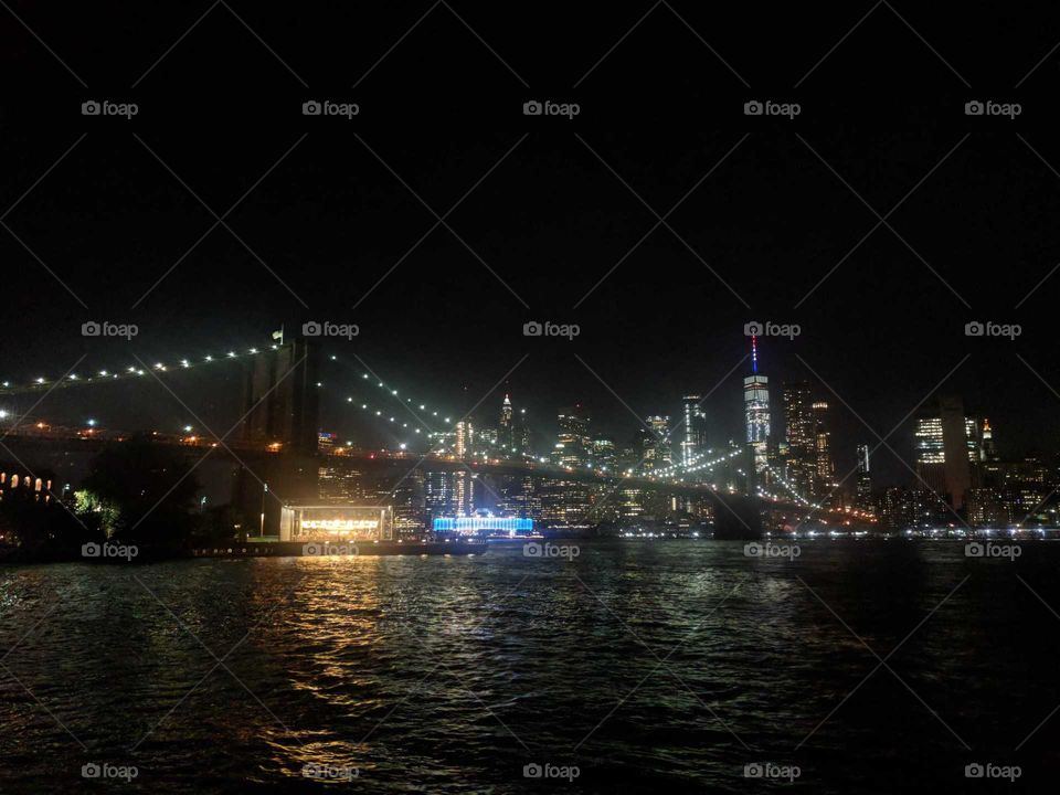New York City Skyline and Brooklyn Bridge All Lit Up at Night Across the East River