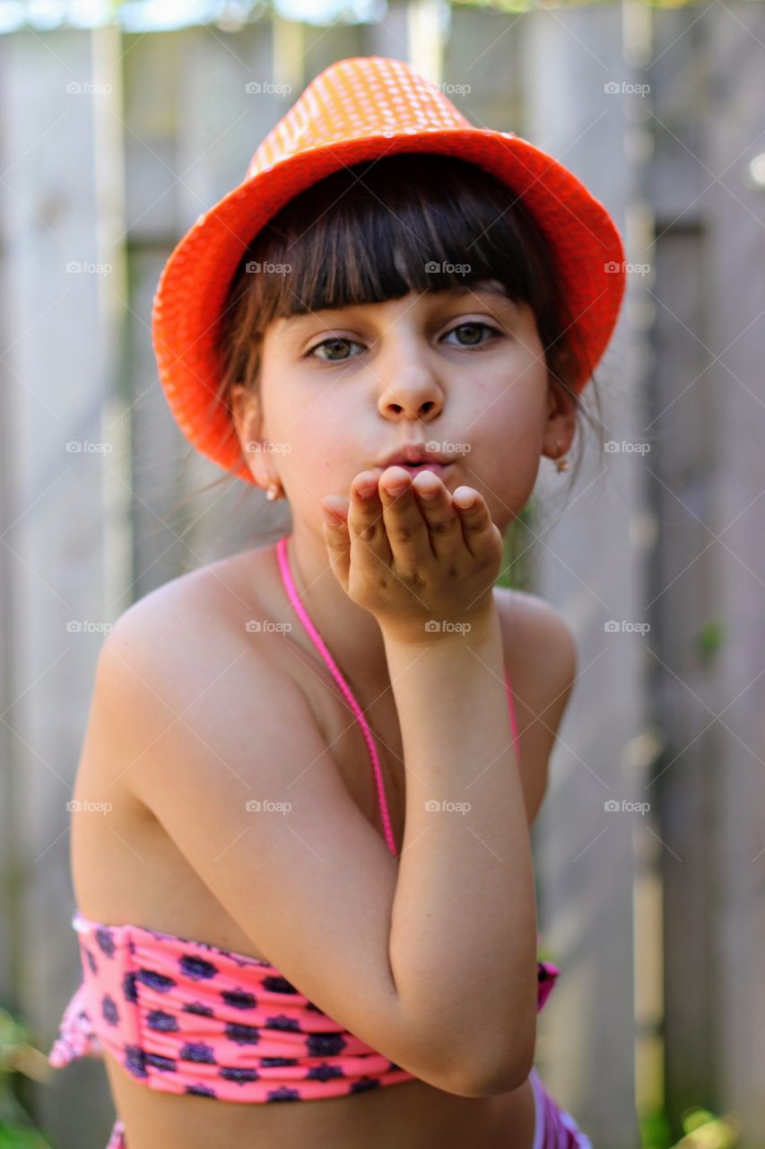 Kiss from a girl in an orange hat