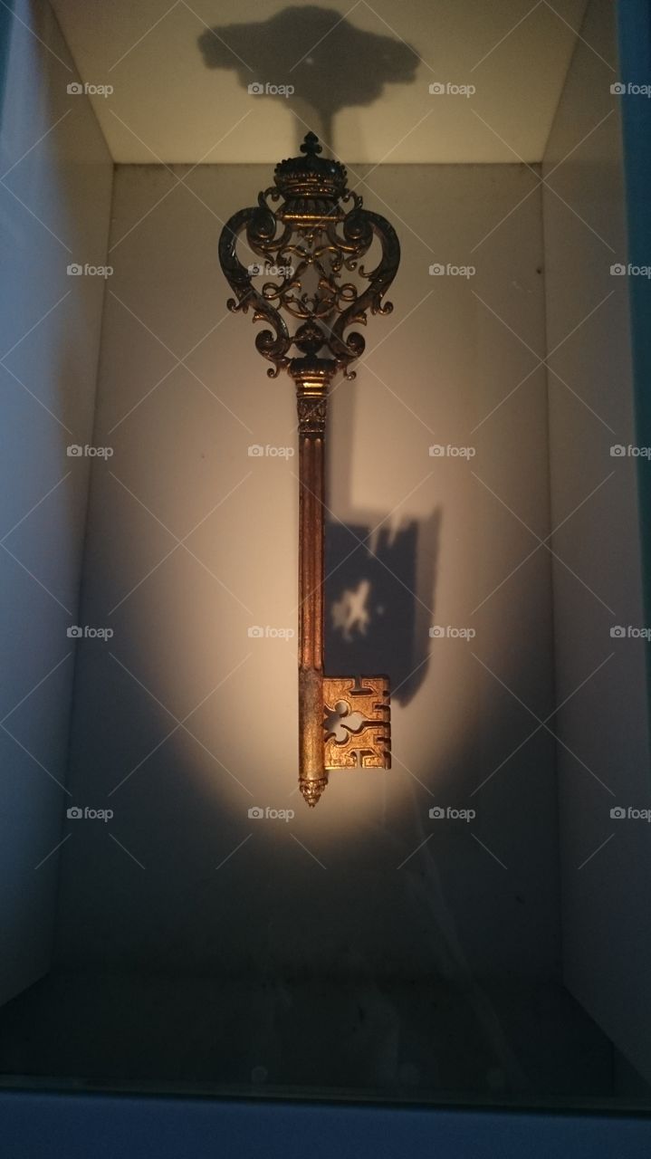 Ancient key hanging on wall