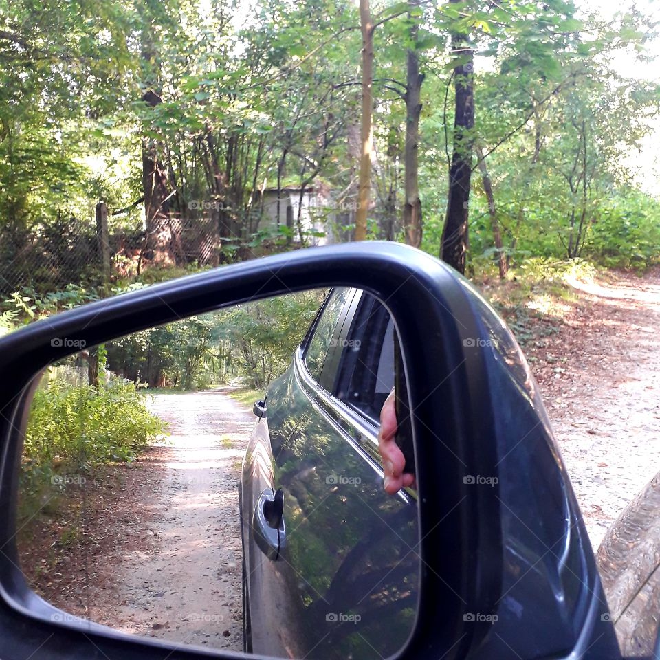 this is your road trip to woodland -  a sand trail seen in the mirror