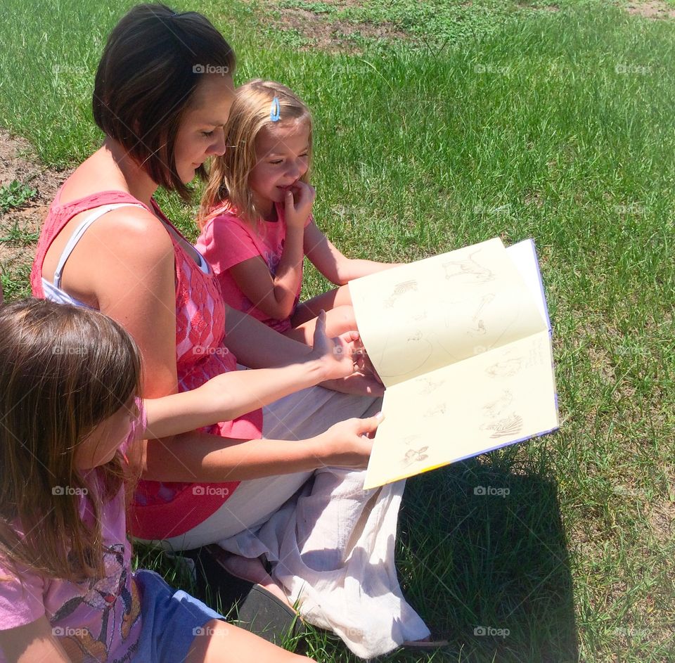 Mother teaching her two daughter