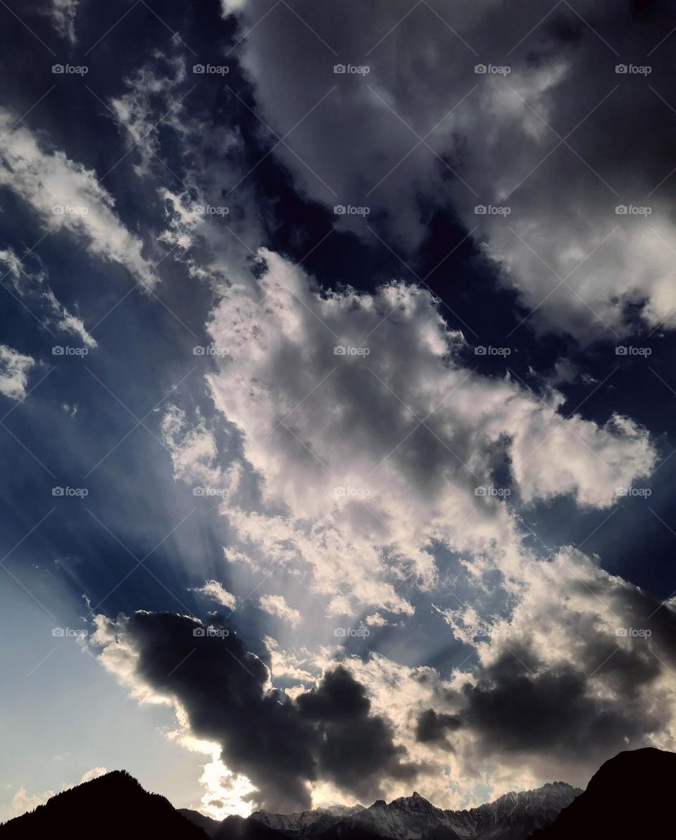 sun rays playing on clouds
