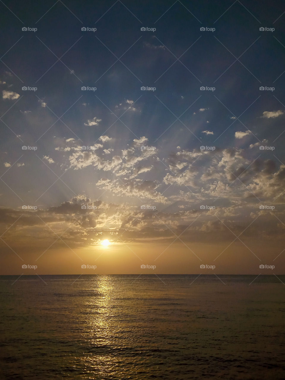 a scenic view of cloudy sky and a golden sea