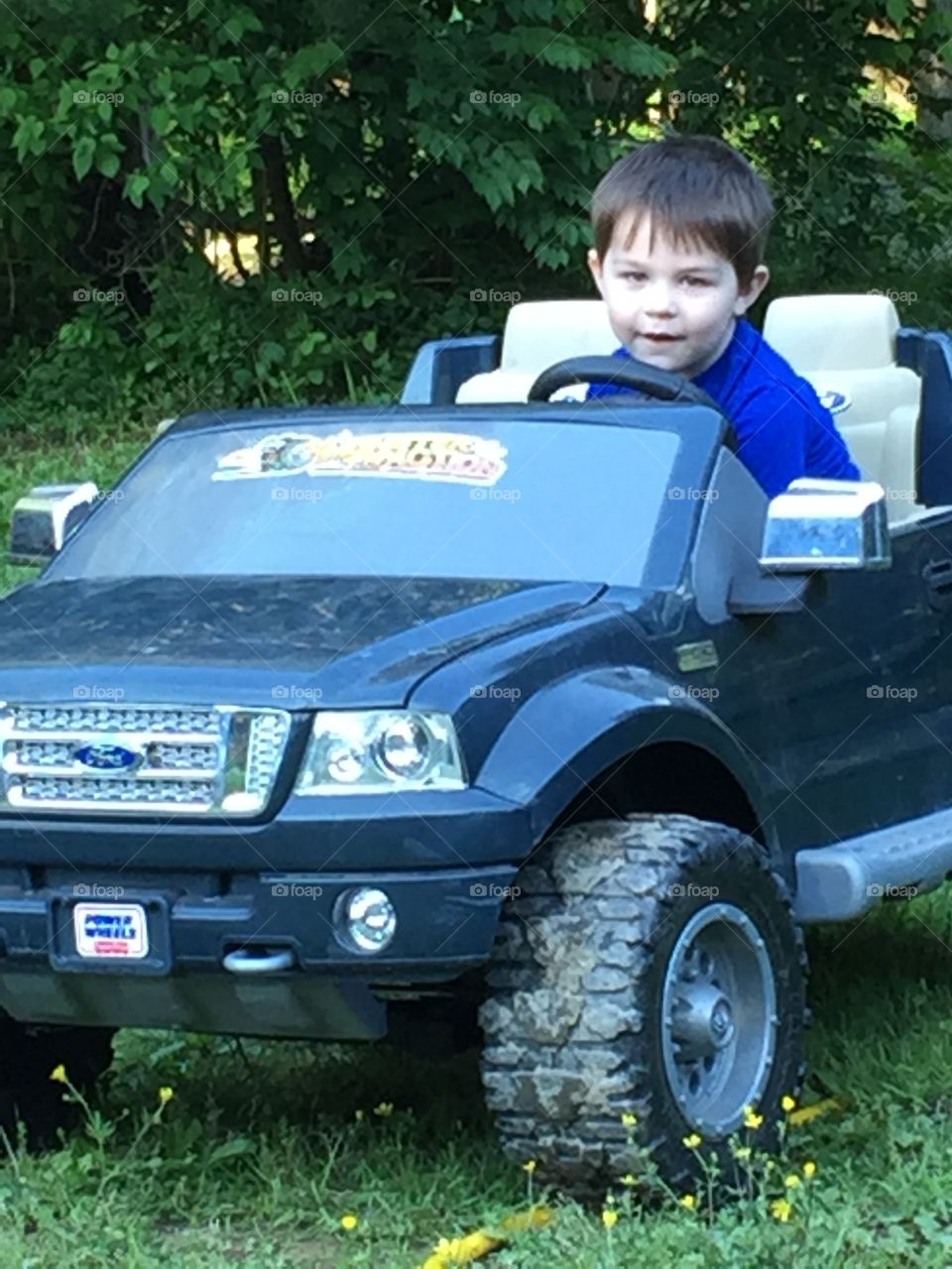 Boy sitting in toy car