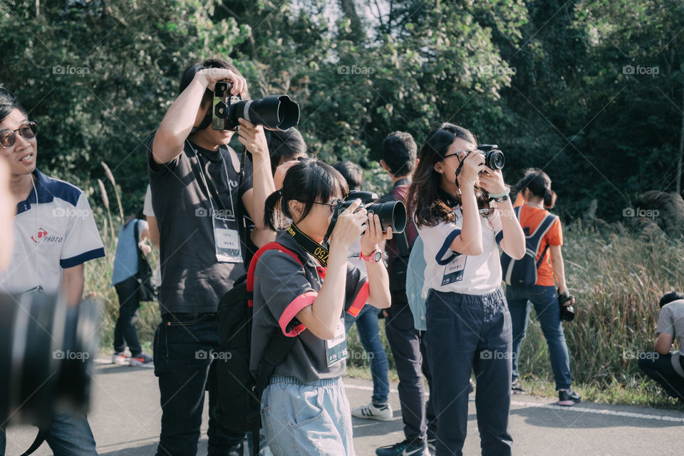 Photographer taking a photo on the road