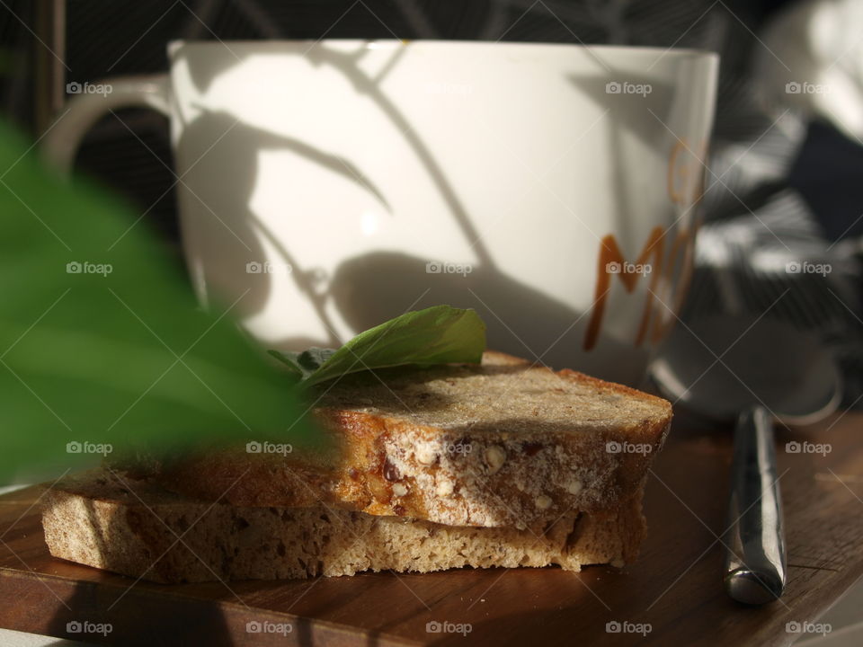 bread with basil next to a warm pumpkin soup