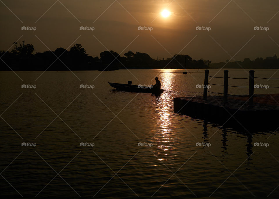 silhouette of fisherman on the lake