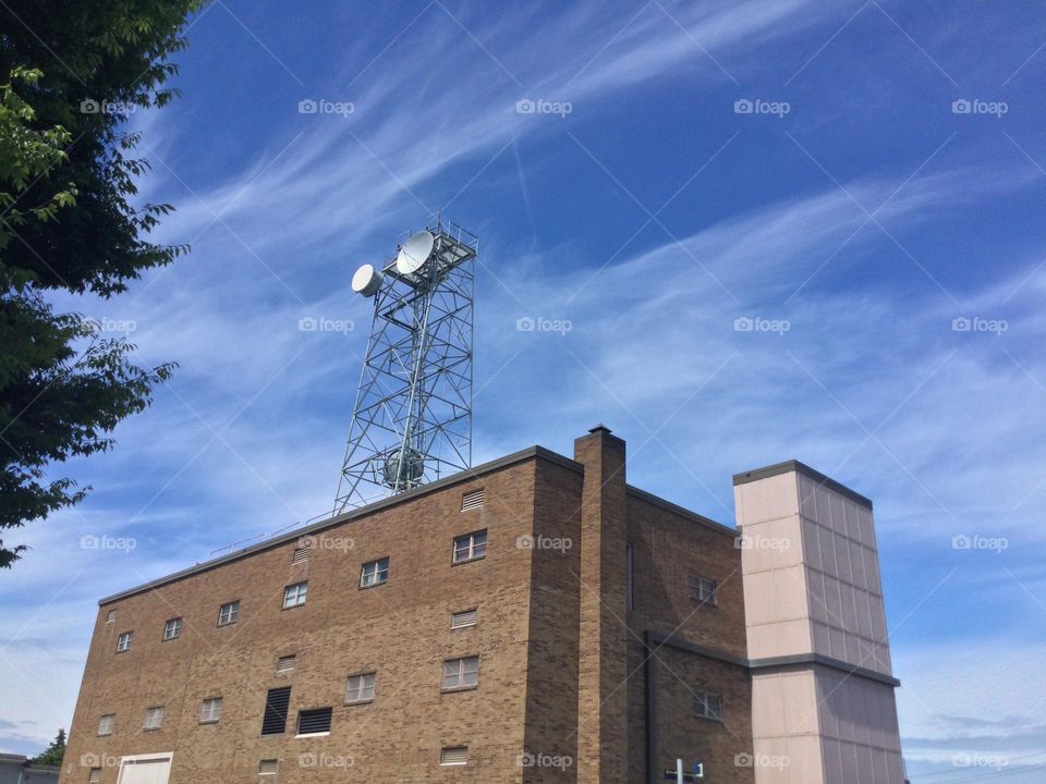 Building with a radio tower on a brick building 