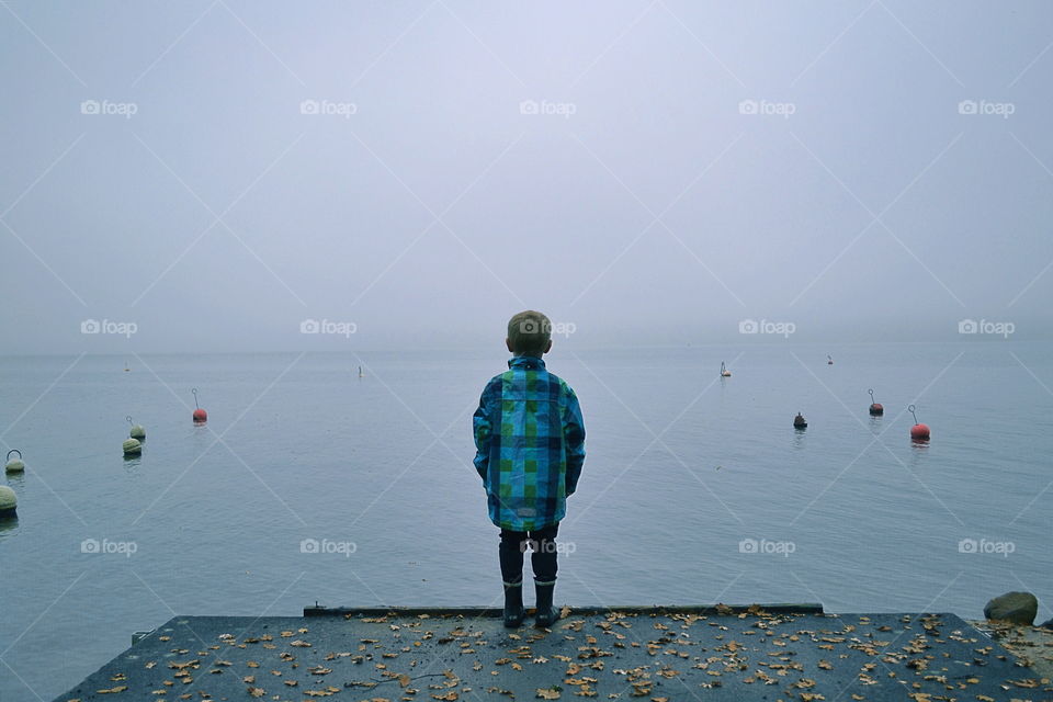 Boy at an foggy lake