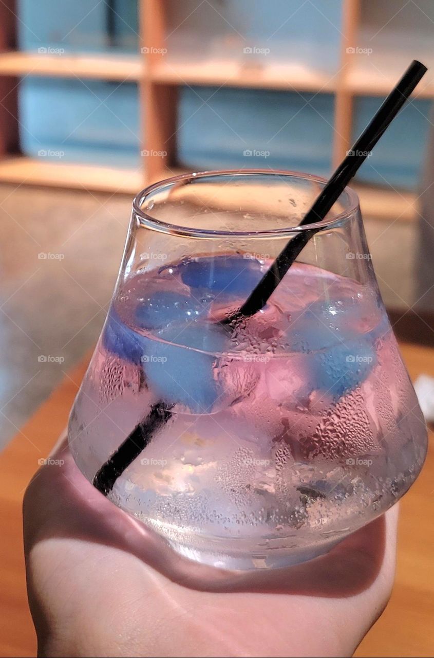 Rum cocktail with blue ice cubes