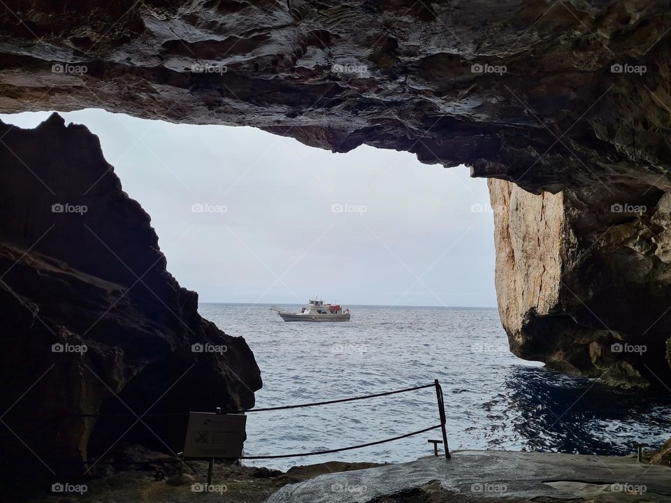 boat photographed from inside the cave of Neptune