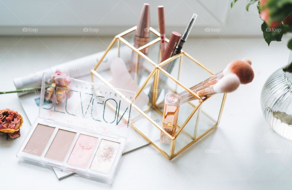 Makeup products on window sill