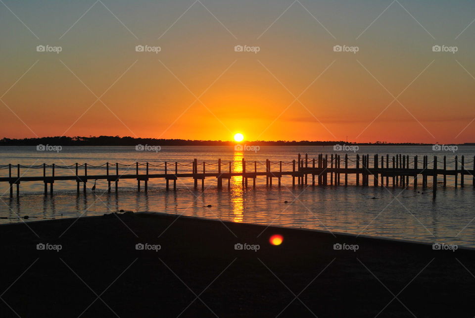 Pier over sea during sunset