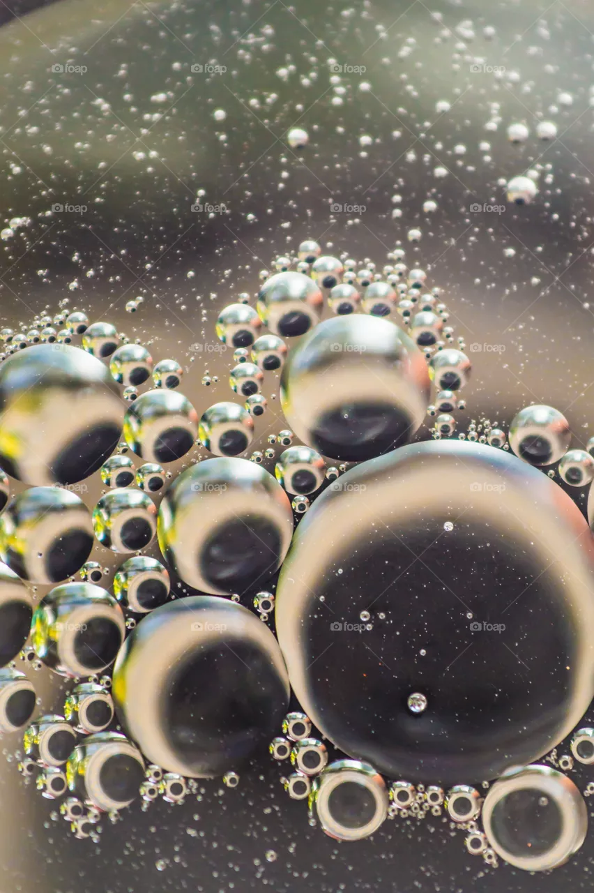 Small bubbles of vegetable oil in water close-up.