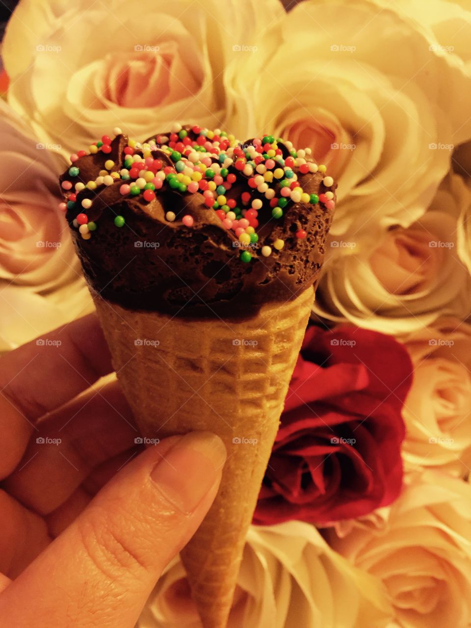 ice cream,hand and roses. hand holding ice cream