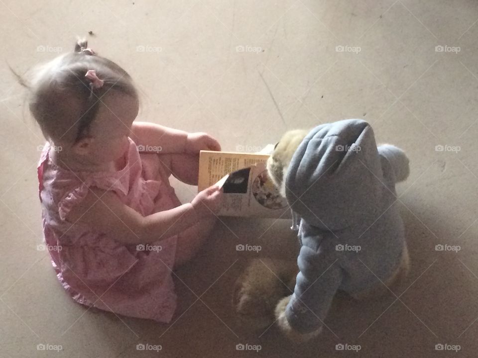 Reading a book to my friend. 