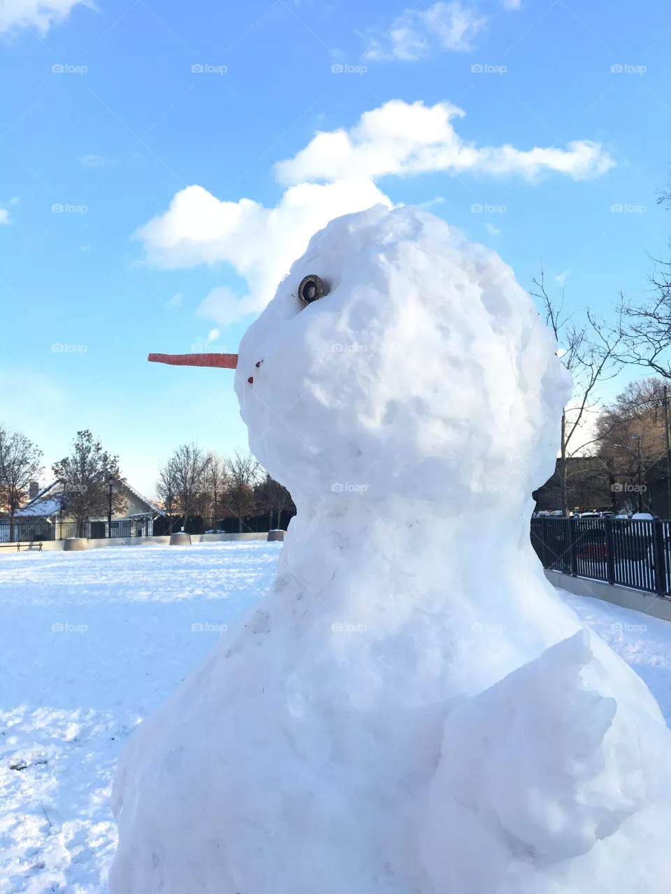 Snowman with blue sky, clouds