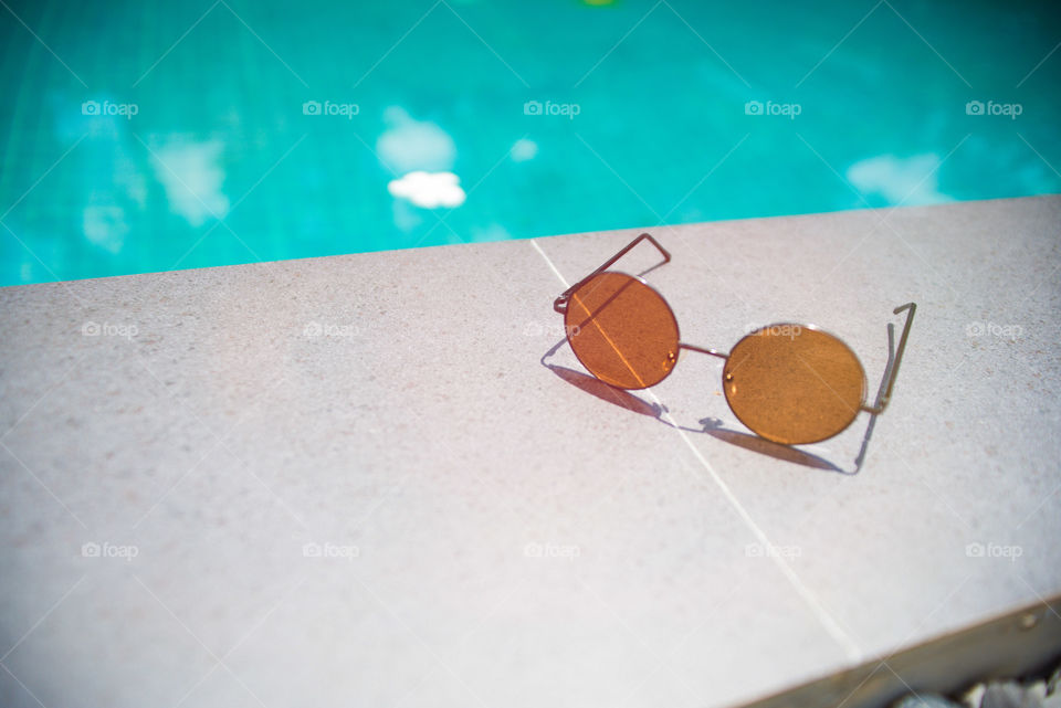 Just the glasses, the pool and the sun. Happy.