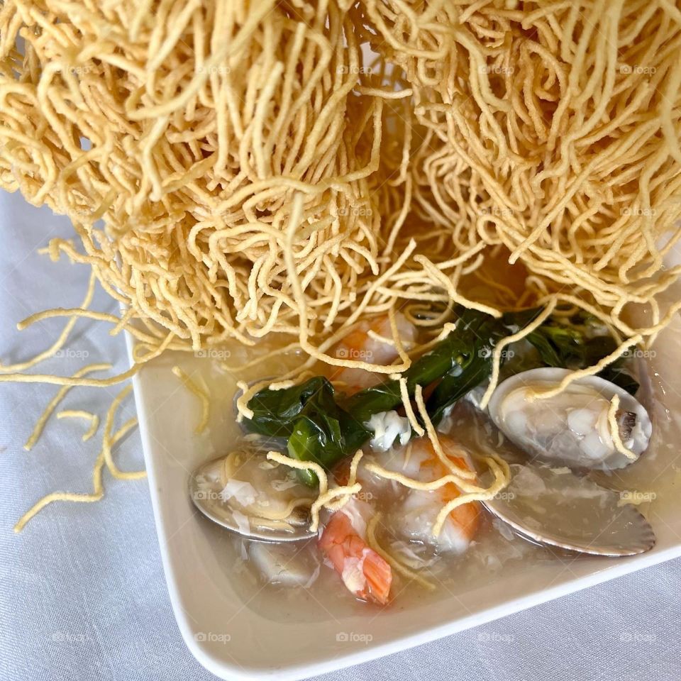 Asian food includes lala clam soup, curry fish head, bitter gourd pork and crispy twin tower noodles 