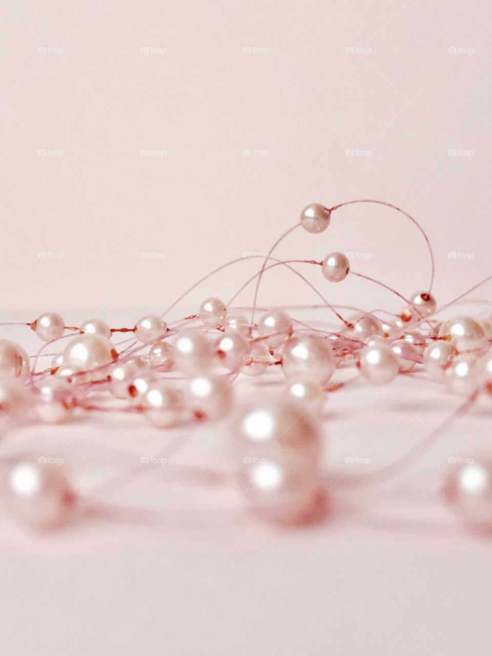 Close-up of pearl necklace on white background
