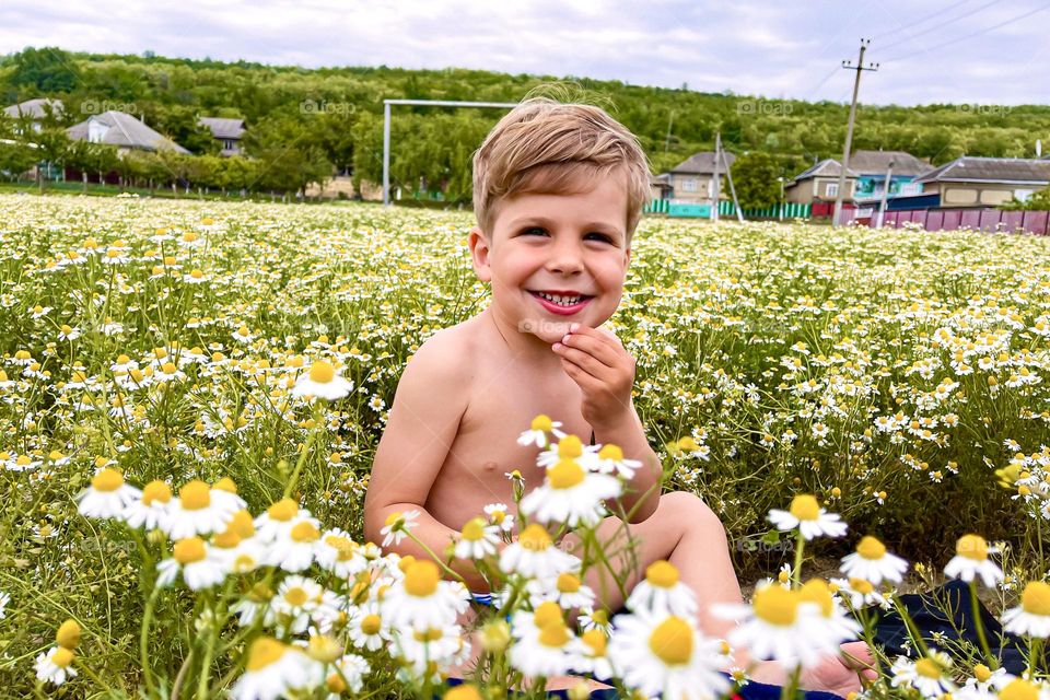 Smiling boy in flowers