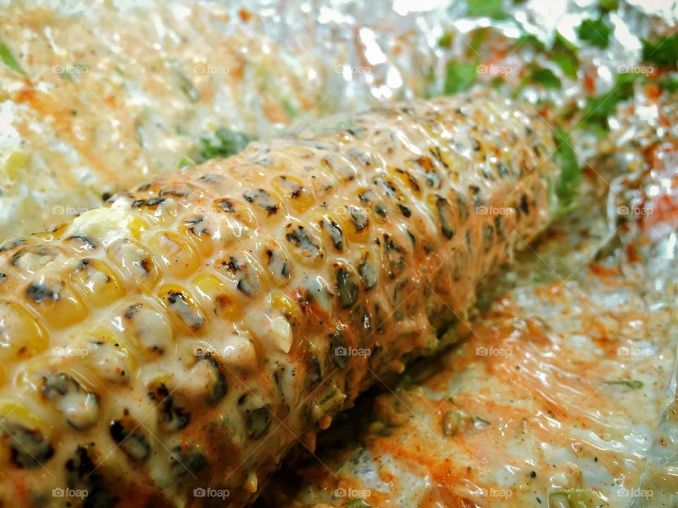 Corn on the cob smothered in goodness.