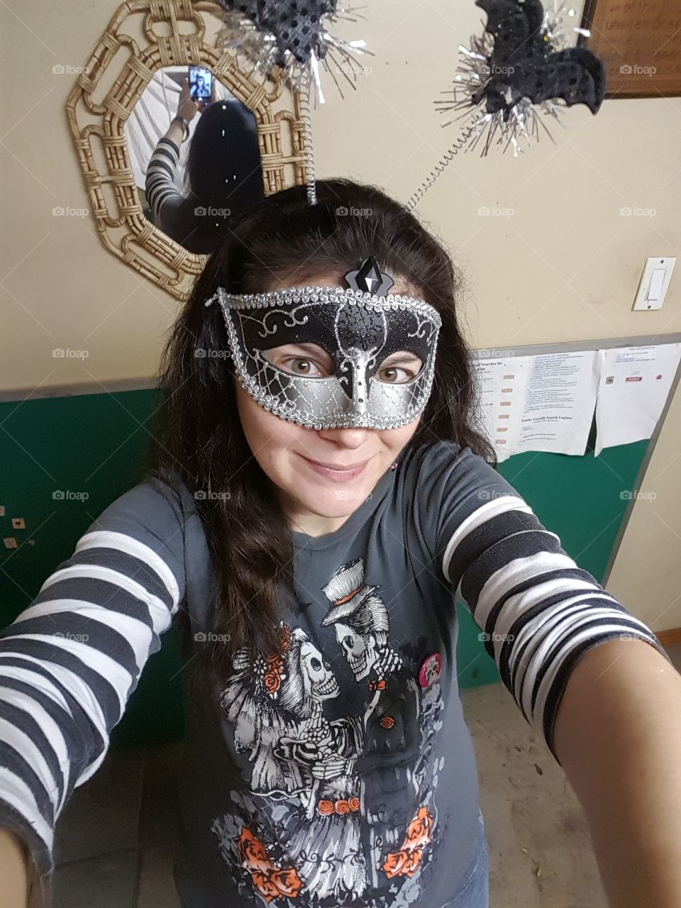 This is my costume. A mask with a batty headband and my long striped sleeve skeleton bride n groom shirt that glows in the dark. I'm also wearing skeleton earrings.