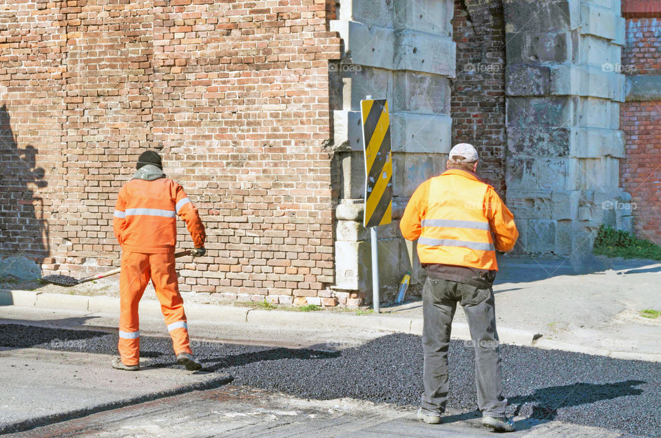 Rear view of man working on construction site.