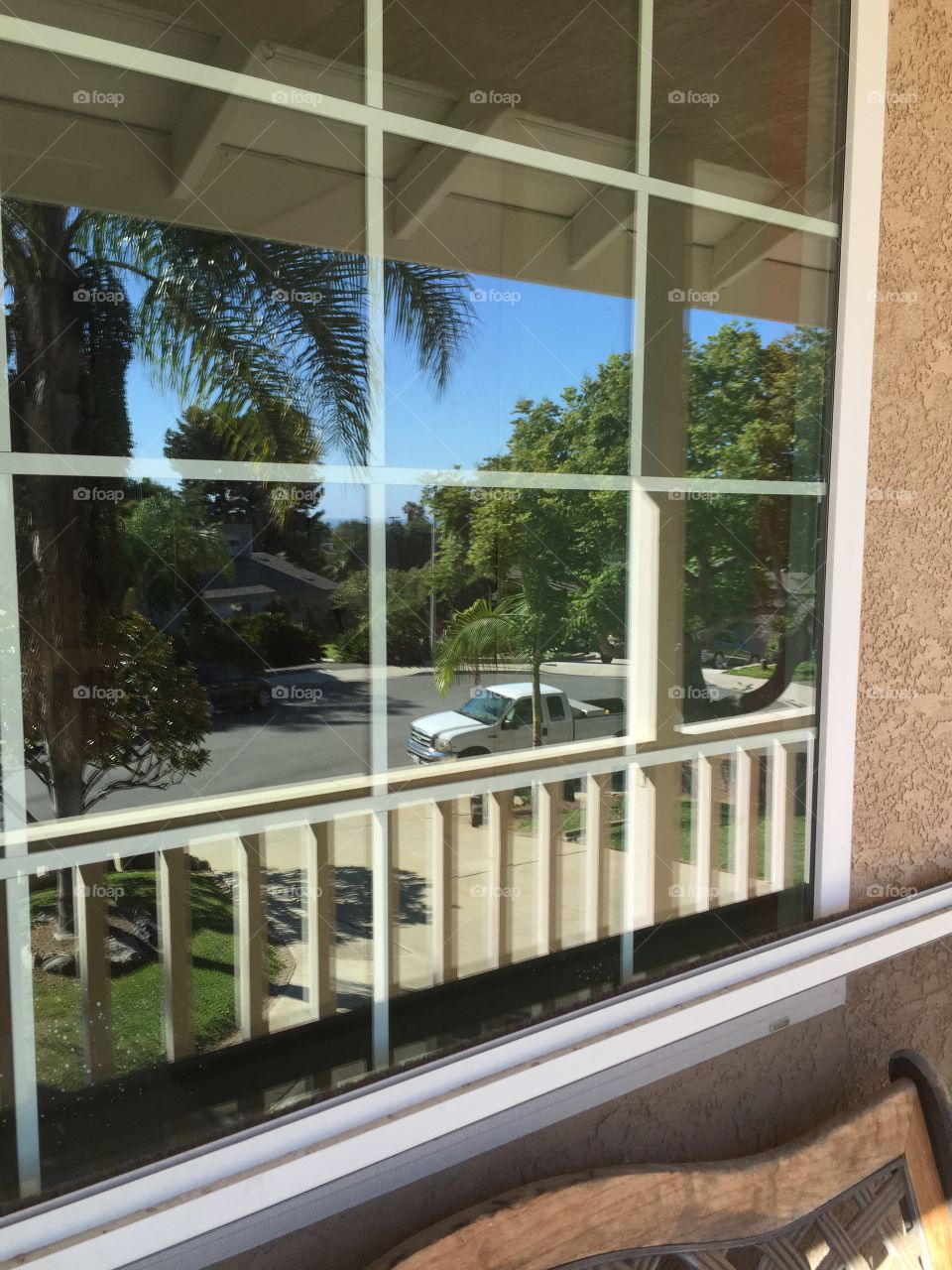 Reflection in my window. . View of the ocean (over the roof) while reflecting from my window. 