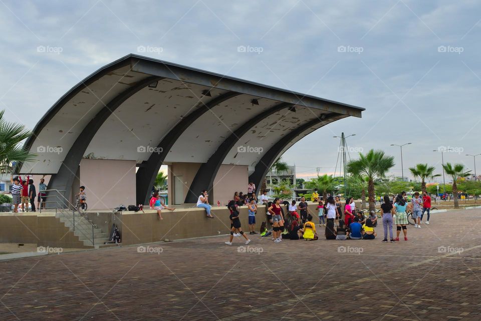 People practicing dancing in a park in the city of machala in ecuador.